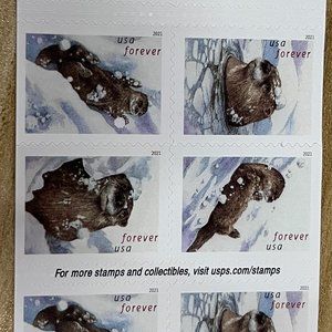 The USPS 2021 Otter in Snow Forever stamp features the theme of fun, winter, and